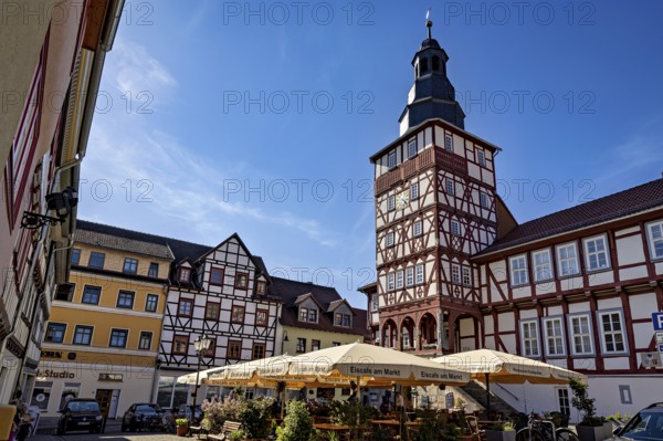 Market square with half-timbered houses and tower under a bright blue sky, The town hall of Treffurt in Thuringia