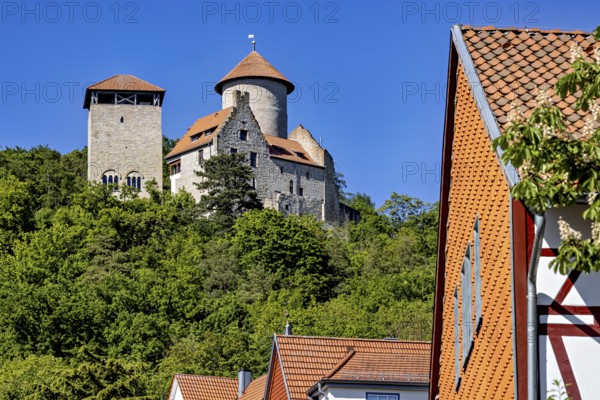 Historic castle with towers above a village with half-timbered houses and lots of greenery, Normannstein Castle near Treffurt in Thuringia