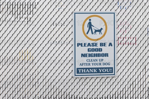 Sign reminds dog owner to clean up after their dog