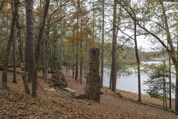 Fireplace chimney remains of a cabin used as a picnic site on the shore of Ivy Lake at Clarko State Park near Quitman, Mississippi, USA