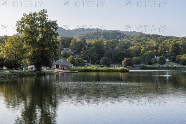 Youth paddles his paddleboard away from Lake Junaluska Outfitters launch in Lake Junaluska, North Carolina