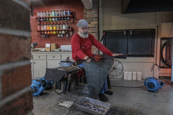 Glass blower demonstrates the art of blowing glass at the Dollywood amusement park in Pigeon Forge, TN