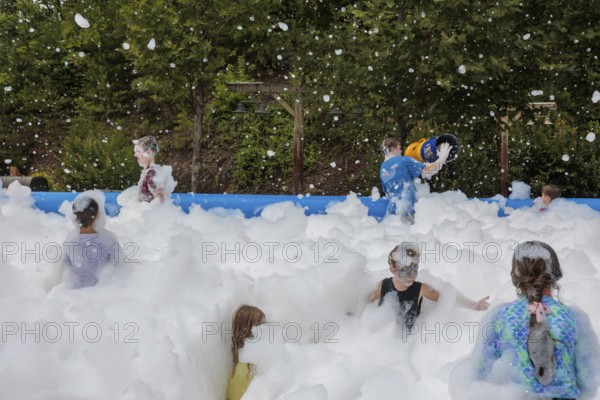 Park guests playing in the bubble foam pit at the Dollywood amusement park in Pigeon Forge, TN
