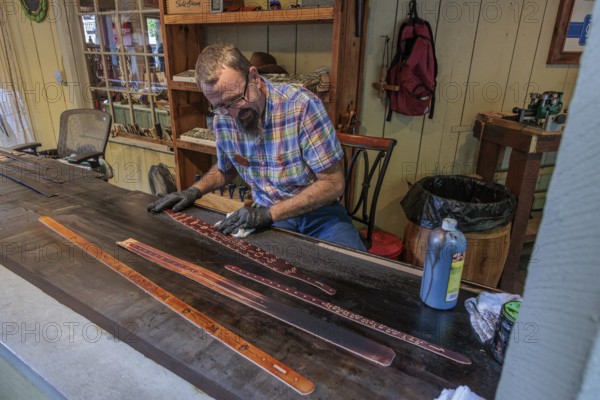 Craftsman demonstrated the art of belt making in Smoky Creek Leather and Hat Company at the Dollywood amusement park in Pigeon Forge, TN