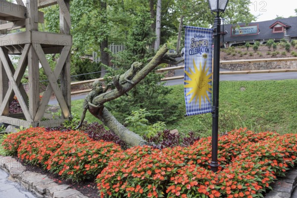Sculpture of a boy chasing a dog chasing a cat up a tree at the Dollywood amusement park in Pigeon Forge, TN
