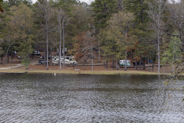Modern and retro recreational vehicles at the campground near the shore of Ivy Lake in Clarko State Park near Quitman, Mississippi, USA