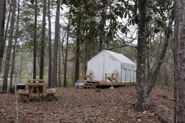 Tentrr glamping tent on a raised platform with a wooden porch at Clarko State Park near Quitman, Mississippi, USA