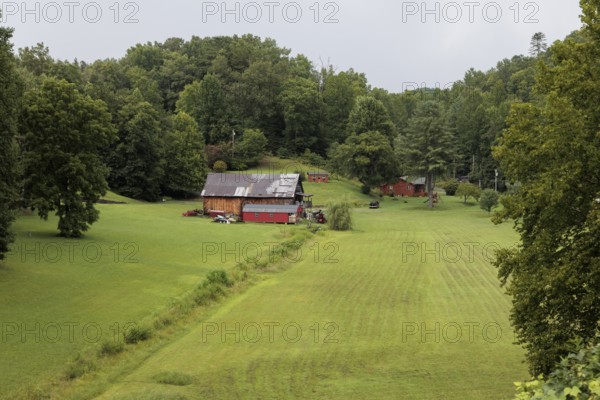 Small family farm in the mountains as seen from the open air car of the Great Smoky Mountains Railroad on its excursion from Bryson City, North Carolina
