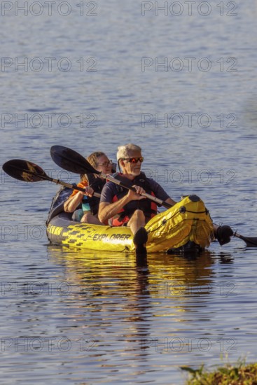 Senior couple paddleing a an inflatable kayak on Archusa Creek Lake at Archusa Creek Water Park near Quitman, Mississippi