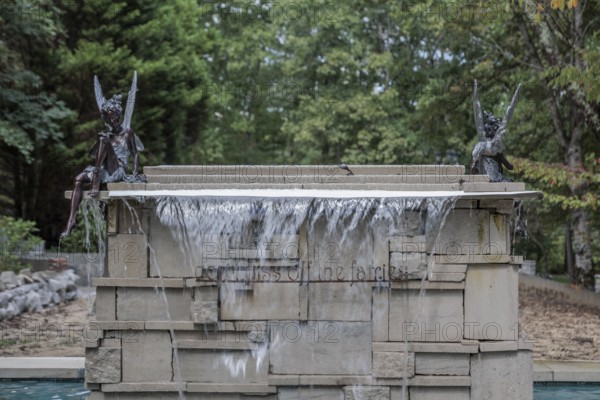 Water fountain with fairies and a sign reading Don't piss off the fairies near the entrance to Dismals Canyon near Phil Campbell, Alabama, USA
