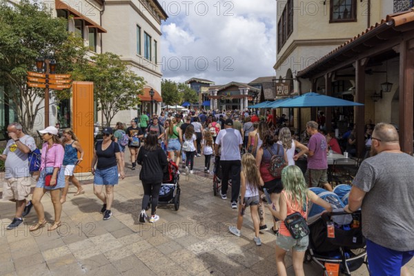 Crowd of visitors walking past The Polite Pig restaurant in Disney Springs at Disney World in Orlando, Florida, USA