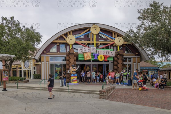 Shoppers and visitors walking past the Once Upon A Toy toy store in Downtown Disney at Disney World in Orlando, Florida, USA