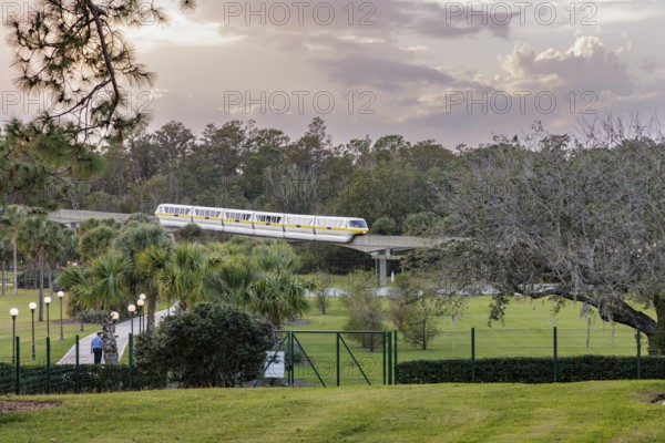 Monorail carries passengers toward the entrance to the Magic Kingdom at Walt Disney World in Orlando, Florida, USA