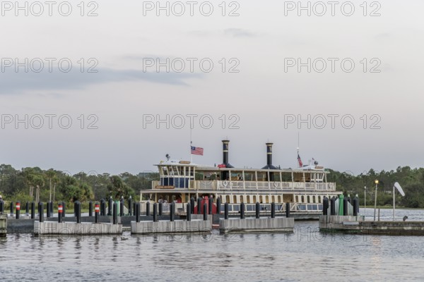 Water taxi General Joe Potter with passengers approaching the dock at the Magic Kingdom in Walt Disney World in Orlando, Florida, USA