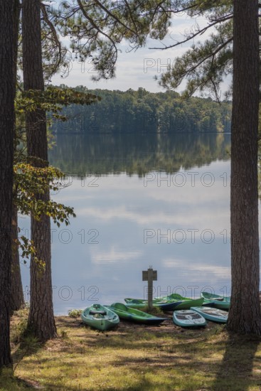 Plastic rental kayaks, canoes and paddleboards on the shore of Pin Oak Lake at The Lodge hotel in Natchez Trace State Park near Wildersville, Tennessee