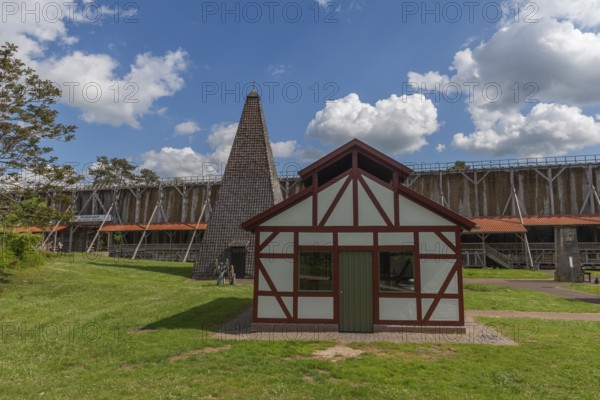 Boiling dung or boiling house to increase the salt concentration in the water, 1000 years of salt production in Bad Sooden, Allendorf, district of Bad Sooden, town history, drilling tower from 1864 above a brine spring, historical landmark graduation tower from 1638, wooden construction, 140 metres long, 12 metres high, open-air inhalatorium, blackthorn, brine air, aerosols, respiratory tract healing, therapy, white gold, brine, inscription, salt production process, blue sky, Werra-Meissner district, Hesse, Germany
