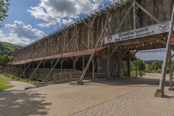 1000 years of salt production in Bad Sooden, Allendorf, district of Bad Sooden, town history, historical landmark graduation tower from 1638, wooden construction, 140 metres long, 12 metres high, open-air inhalatorium, blackthorn, brine air, aerosols, respiratory tract healing, therapy, white gold, brine, inscription, blue sky, clouds, Werra-Meissner district, Hesse, Germany