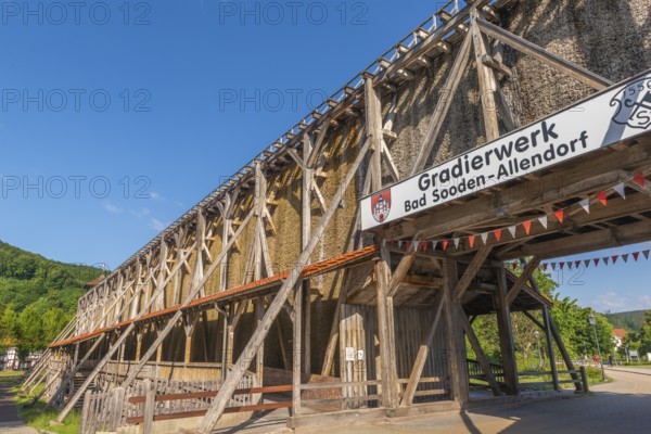 1000 years of salt production in Bad Sooden, Allendorf, district of Bad Sooden, town history, historical landmark graduation tower from 1638, wooden construction, 140 metres long, 12 metres high, open-air inhalatorium, blackthorn, brine air, aerosols, respiratory tract healing, therapy, white gold, brine, inscription, blue sky, Werra-Meissner district, Hesse, Germany