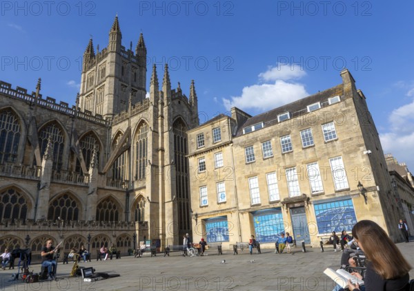 Busker musician performing in Bath Abbey church yard, city of Bath, north east Somerset, England, UK