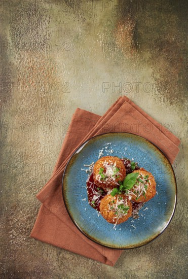 Crispy Arancini appetizer, with parmesan cheese and microgreens, plate, tomato sauce, homemade, no people