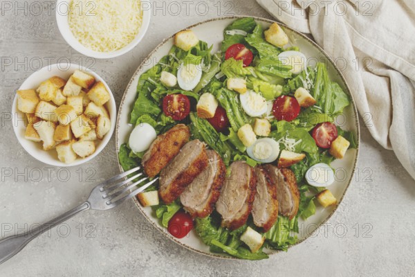 Caesar salad, with duck breast, on a light plate, on a light background, homemade, no people