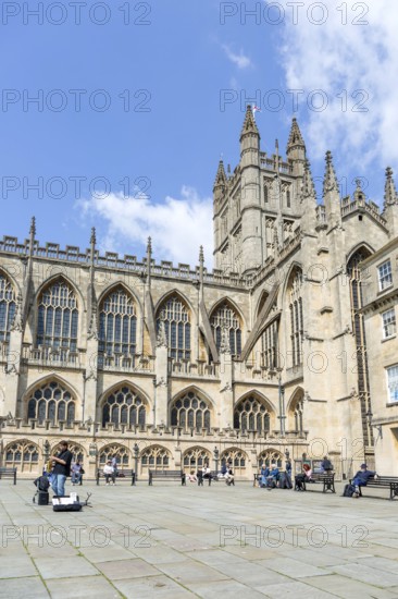 Busker musician performing in Bath Abbey church yard, city of Bath, north east Somerset, England, UK