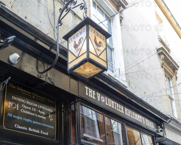 Vintage Courage pub lamp sign outside The Volunteer Rifleman's Arms pub, city of Bath, north east Somerset, England, UK