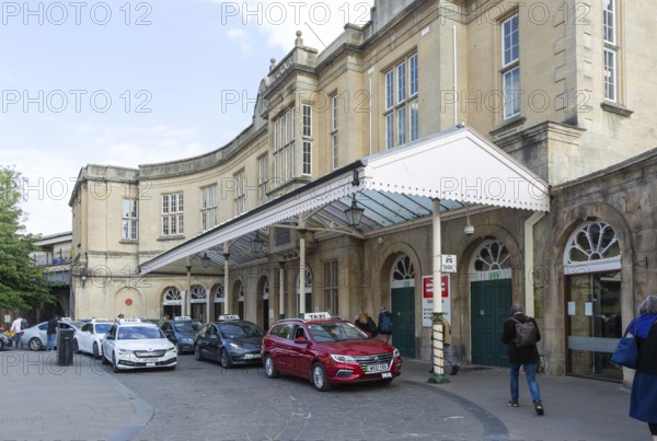 Taxis outside Bath Spa railway station, city of Bath, north east Somerset, England, UK