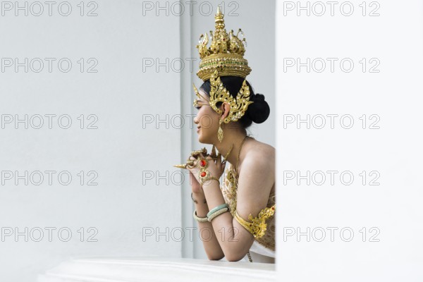 Thai traditionally and festively dressed young woman, Wat Pho, Bangkok, Thailand
