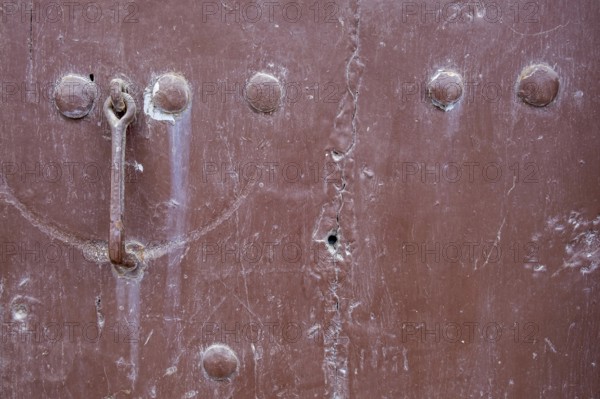 Close-up of a brown metallic surface with rust and bolts, background, texture, Prizren, Kosovo