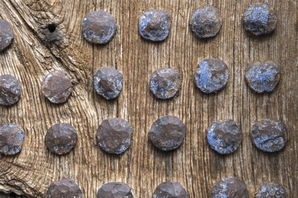 Old wooden door with rusty metal rivets at regular intervals, North Macedonia, Balkans