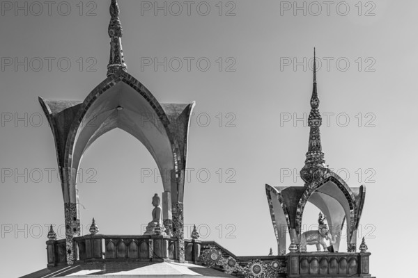 Round arch pavilions decorated with mosaics and glass works of art, black and white photo, Buddhist temple complex Wat Phra That Sorn Kaew, Phetchabun province, Thailand