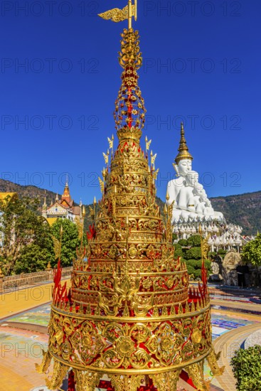 Gilded chedi, the five-headed Buddha statue in the back, Wat Phra That Sorn Kaew Buddhist temple complex, Phetchabun province, Thailand