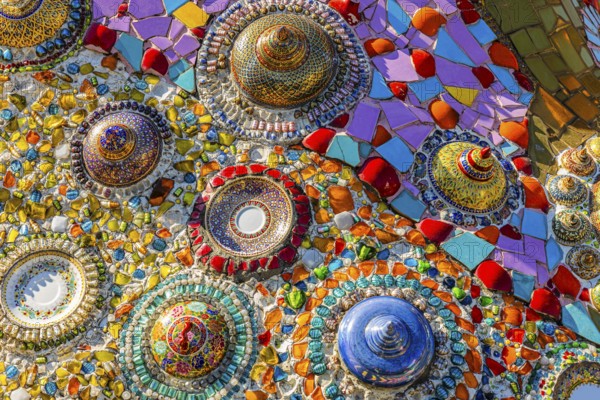 Wall covering with colorful mosaic tiles and incorporated bowls, Buddhist temple complex Wat Phra That Sorn Kaew, Phetchabun province, Thailand