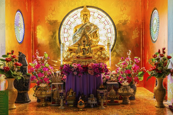 Shrine with gilded Buddhist statue in the main pagoda, Buddhist temple complex Wat Phra That Sorn Kaew, Phetchabun province, Thailand