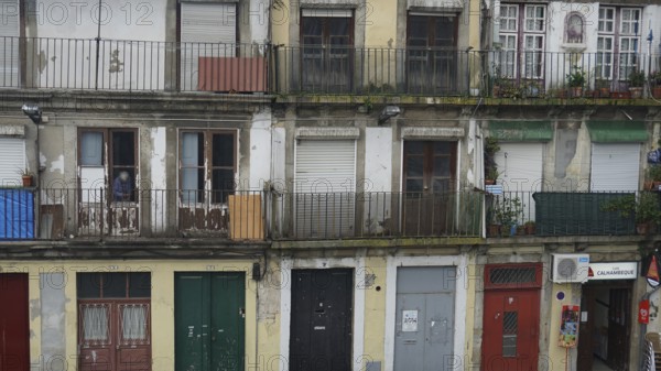 Façade of an old building with several balconies and shutters, Porto, Portugal