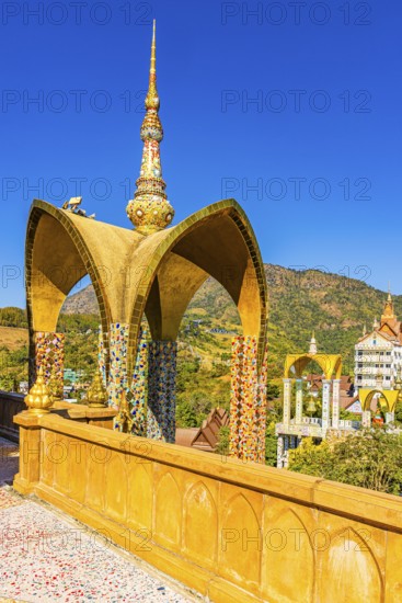 Round arch pavilion decorated with colorful mosaics and glass works of art, Wat Phra That Sorn Kaew Buddhist temple complex, Phetchabun province, Thailand