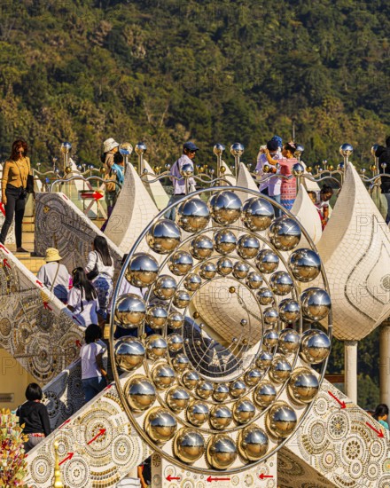 Visitors on the pedestal structure of the five-headed Buddha statue, Wat Phra That Sorn Kaew Buddhist temple complex, Phetchabun province, Thailand
