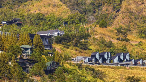 Residential complex with modern residential buildings, behind the Wat Phra That Sorn Kaew Buddhist temple complex, Phetchabun province, Thailand