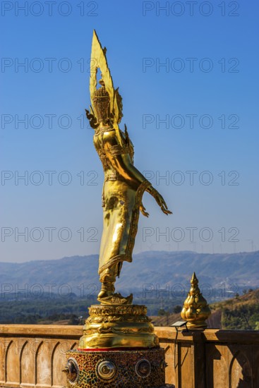 Standing gilded Buddha statue on a viewing terrace, Wat Phra That Sorn Kaew Buddhist temple complex, Phetchabun province, Thailand
