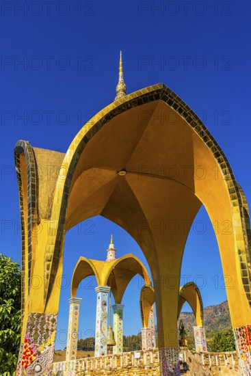 Round arch pavilions decorated with colorful mosaics and glass works of art, Buddhist temple complex Wat Phra That Sorn Kaew, Phetchabun province, Thailand