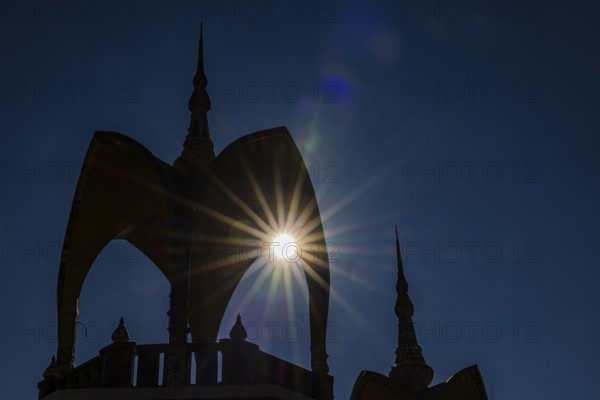 The sun shines through a round arch pavilion, Wat Phra That Sorn Kaew Buddhist temple complex, Phetchabun province, Thailand