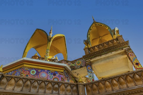 Round arch pavilions decorated with colorful mosaics and glass works of art, Buddhist temple complex Wat Phra That Sorn Kaew, Phetchabun province, Thailand