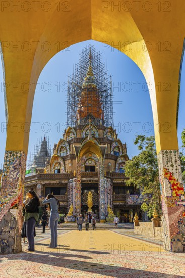 Round arch pavilion, the equipped main pagoda at the back, Buddhist temple complex Wat Phra That Sorn Kaew, Phetchabun province, Thailand