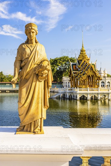 Stone female figure on Dolls Bridge, in the back the open, gilded pavilion, Buddhist temple complex, summer palace of the Thai king, Bang Pa-In, near Ayutthaya, Thailand