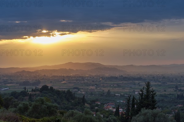 Panoramic view of a peaceful landscape at sunset with lush vegetation, Hotel Europa, garden restaurant and view of the surrounding landscape, Olympia, Peloponnese, Greece