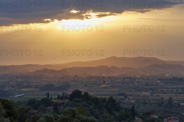 Impressive evening mood with sweeping views over fields and hills in the distance, Hotel Europa, garden restaurant and views of the surrounding countryside, Olympia, Peloponnese, Greece
