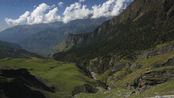 Green valleys and mountains under a partly cloudy sky, trekking in Ladakh, Manali-Leh Highway, Himachal Pradesh, India