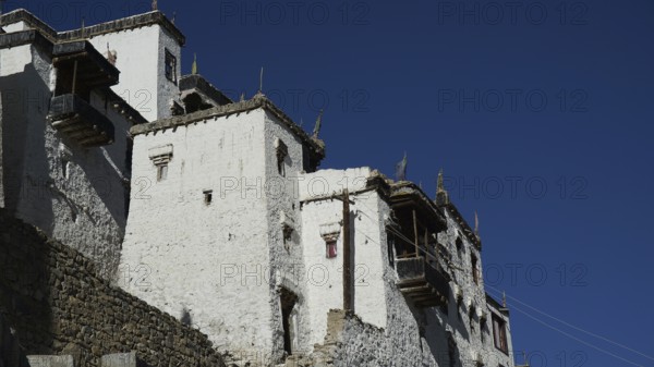 Close-up of the facade of Thiksey Buddhist monastery with deep blue sky, trekking in Ladakh, Himalayas, India