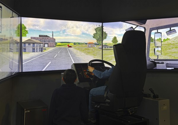 Truck simulator with children at DASA, German Occupational Safety Exhibition, Dortmund, Ruhr area, North Rhine-Westphalia, Germany